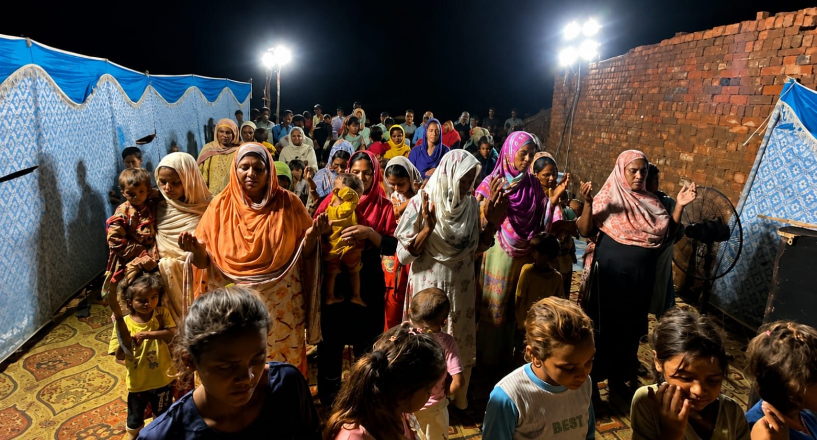 Women and children praying at a night worship gathering in Punjab, Pakistan
